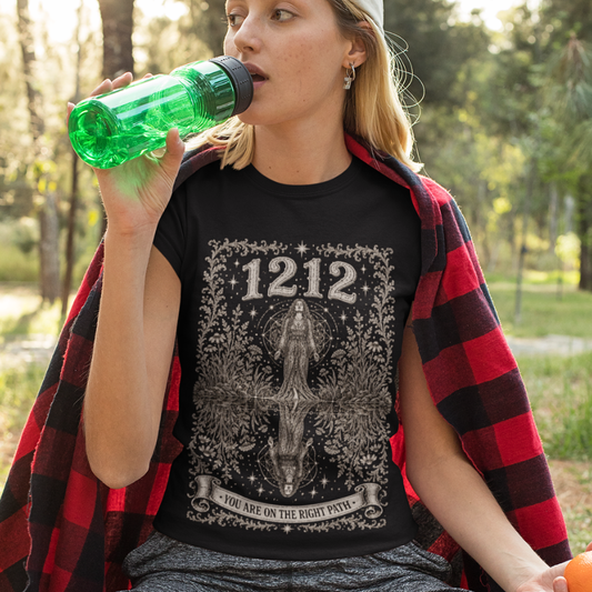 Woman wearing 1212 black sacred yoga shirt in a forest clearing — Dark Sacred Stillness collection by Ramro Yoga Wear
