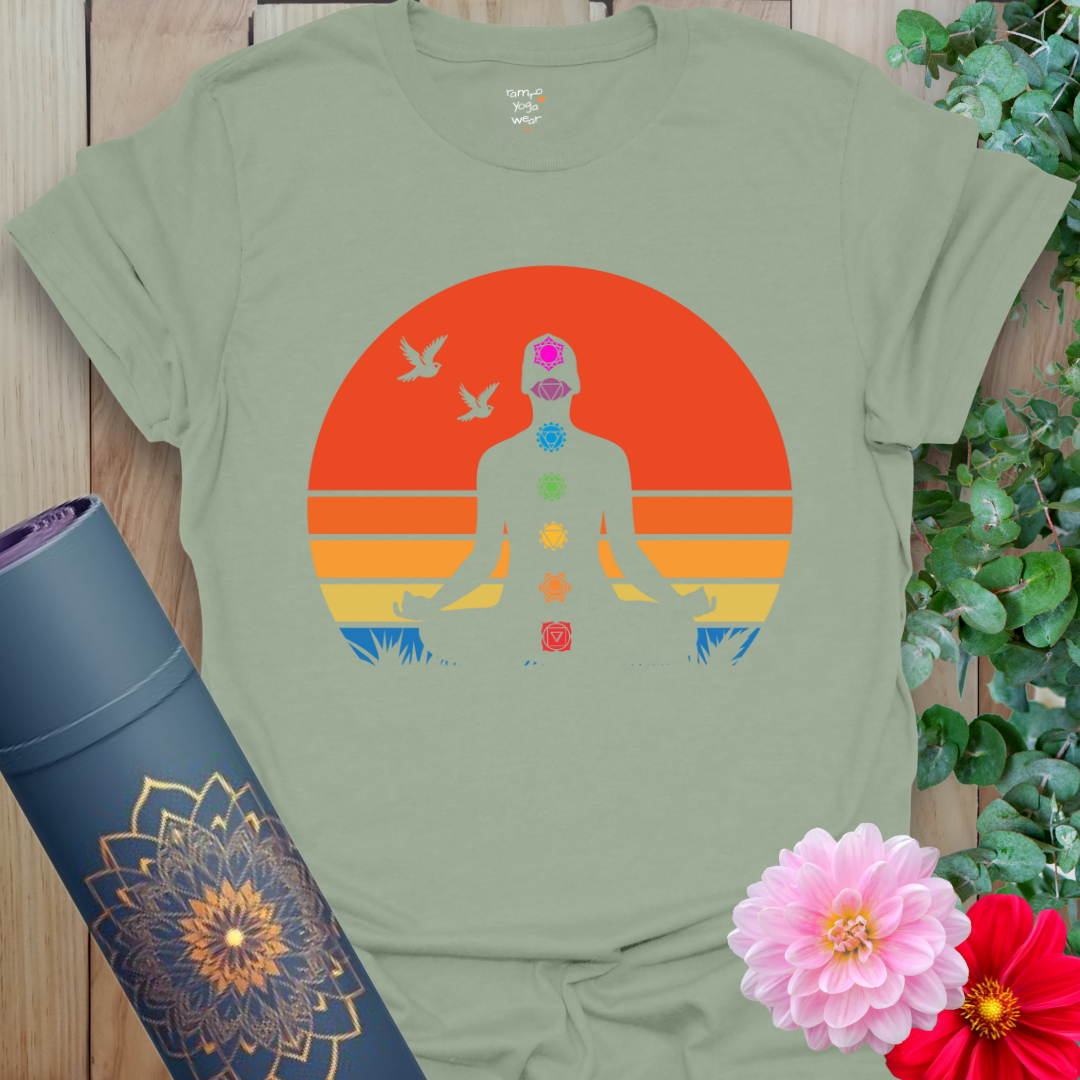 Flatlay of sage green 7 Chakra T-Shirt with colorful chakra design and meditating figure crafted by Ramro Yoga Wear.