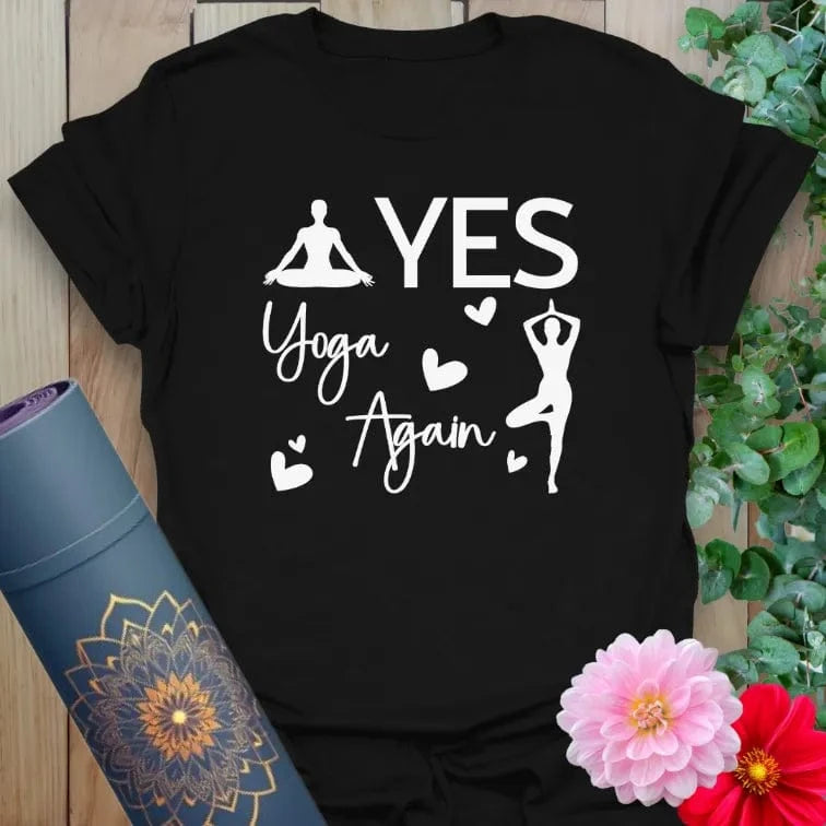 Designed by Ramro, this flatlay of black Again T-Shirt featuring white “YES YOGA AGAIN” graphic with tree pose silhouette, mindful and empowering.