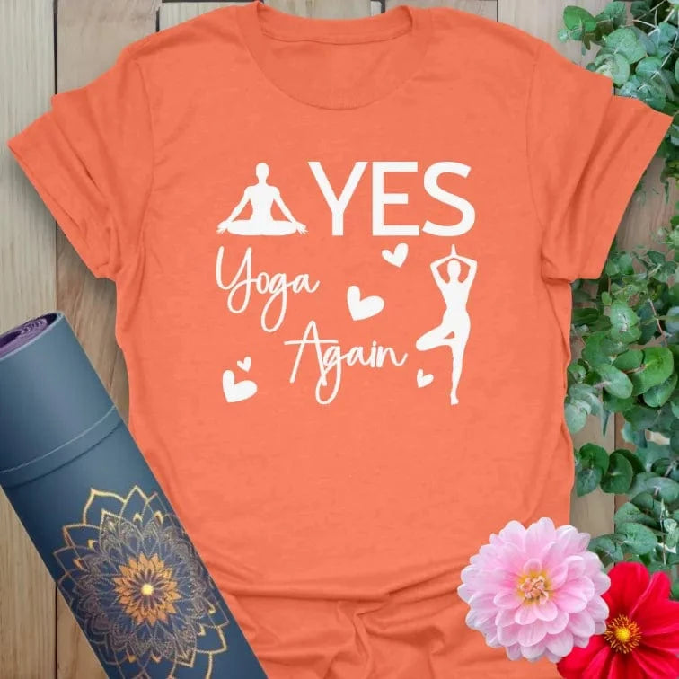 Flatlay of heather orange Again T-Shirt with bold “YES YOGA AGAIN” message in white, perfect for yogis with soul.