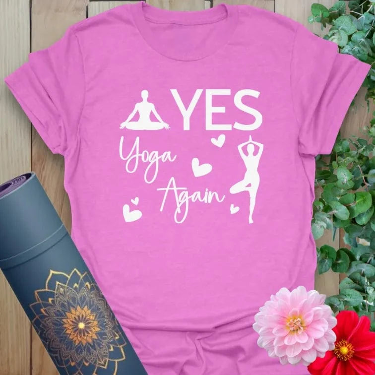Flatlay of heather radiant orchid Again T-Shirt with bold white “YES YOGA AGAIN” text and yoga pose graphic designed by Ramro Yoga Wear.