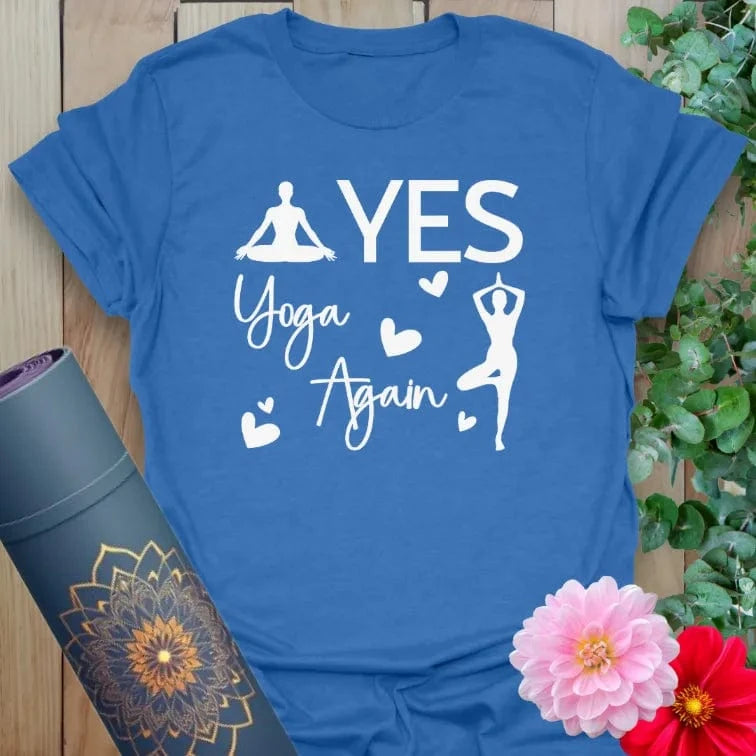 Flatlay of heather royal blue Again T-Shirt with playful “YES YOGA AGAIN” print in white, soft and mindful apparel.