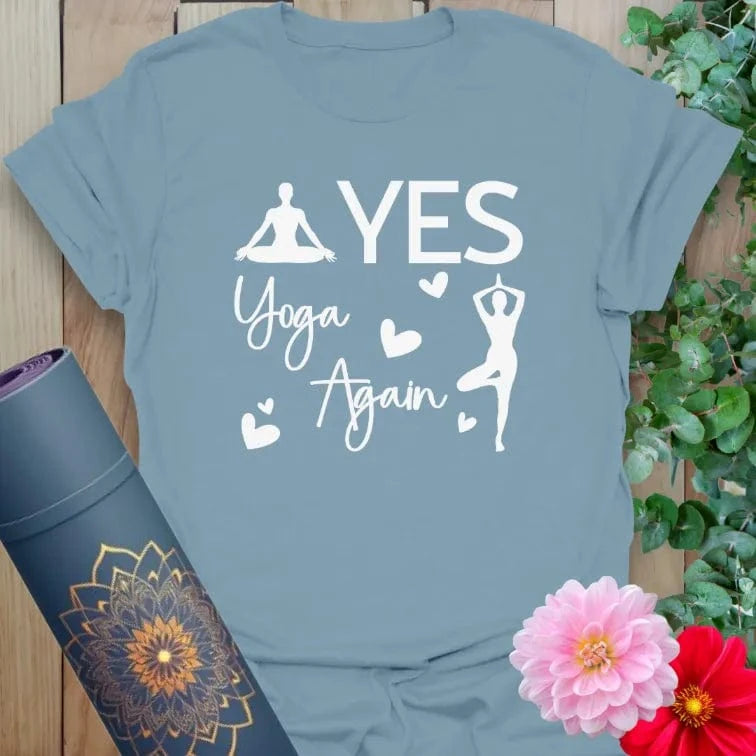 Ramro's flatlay of Stone Blue Again T-Shirt featuring inspiring “YES YOGA AGAIN” message in white and a yoga pose silhouette.