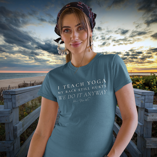 Woman wearing Anyway Heather Deep Teal yoga teacher gift tee on a beach boardwalk at sunset — Yoga Teacher Gifts collection by Ramro Yoga Wear