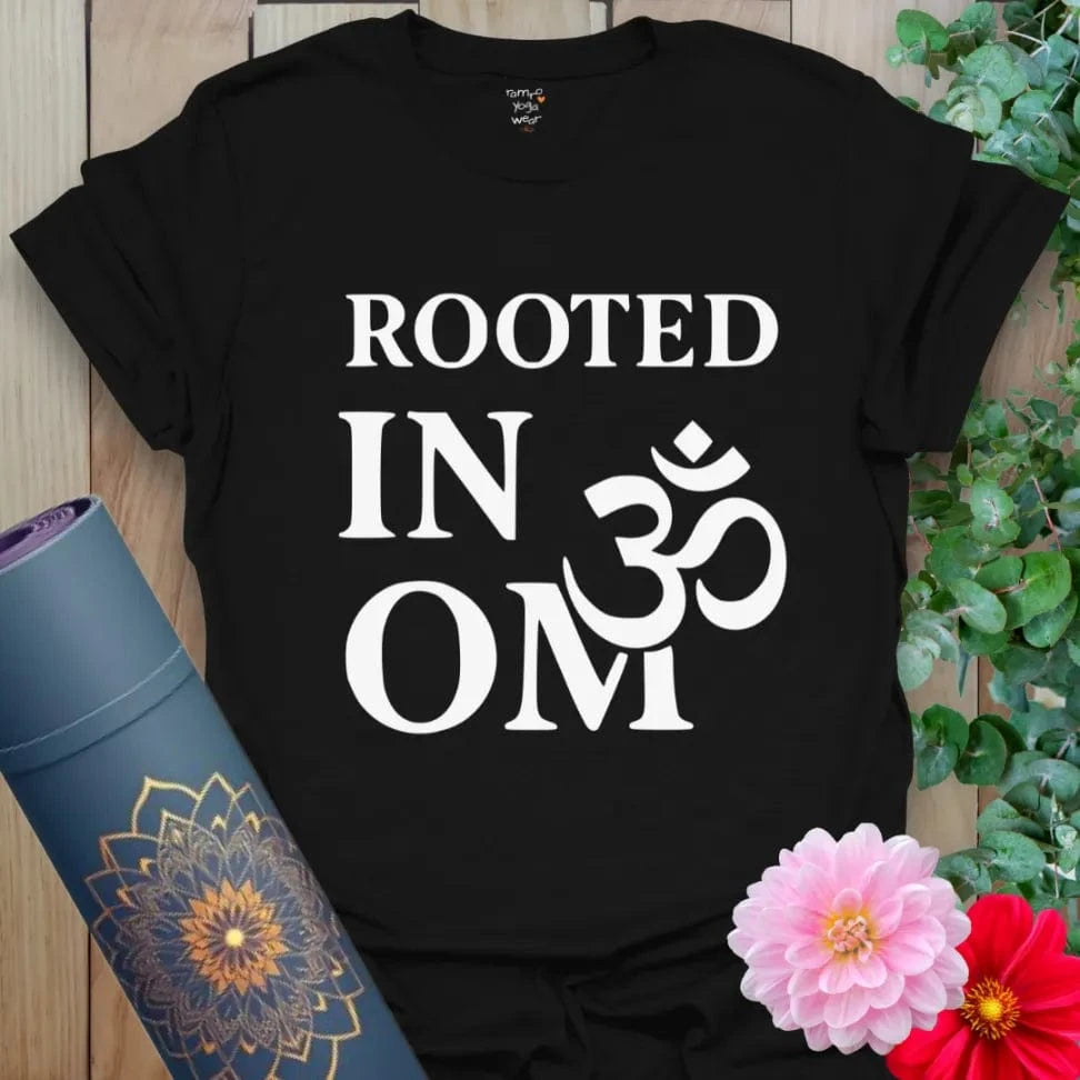 Black yoga t-shirt with bold white "Rooted in OM" text and sacred OM symbol