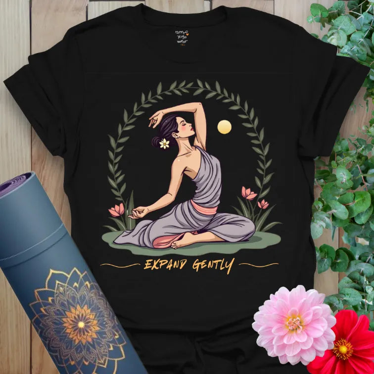 Classic black cotton yoga t-shirt with elegant yogi, sun, and floral design symbolizing patience and mindful movement.