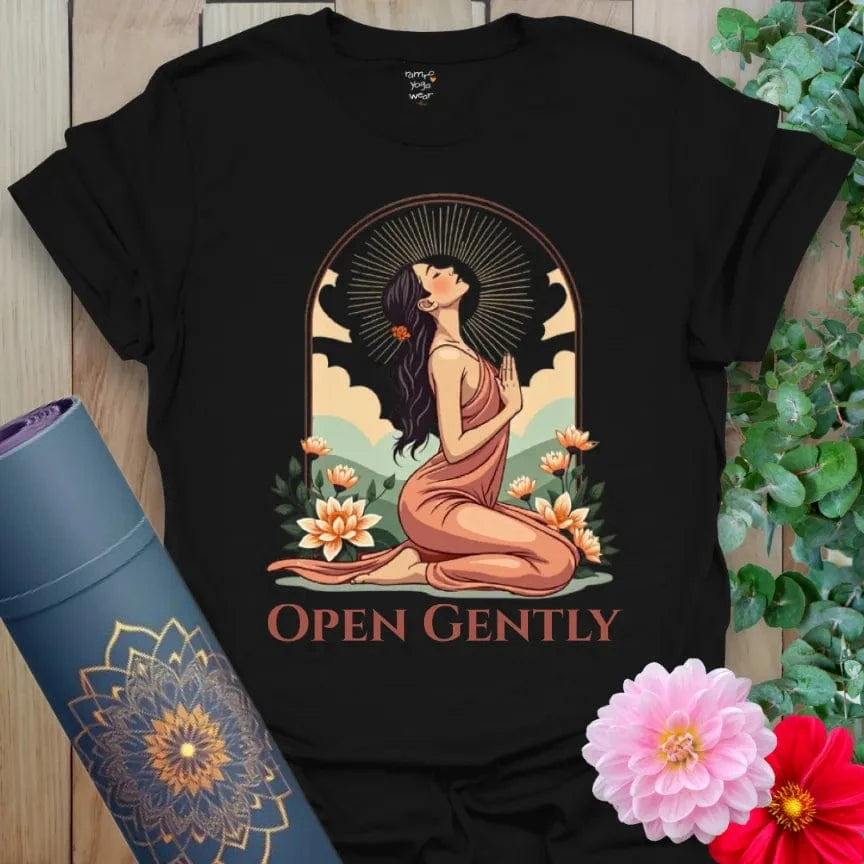 Classic black cotton yoga t-shirt showcasing elegant heart-opening yoga pose framed by blooming flowers and radiant skies.
