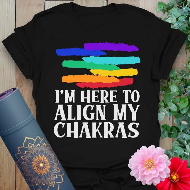 Classic black cotton yoga t-shirt featuring bold chakra quote and rainbow brushwork for soulful expression and playful spiritual vibes.