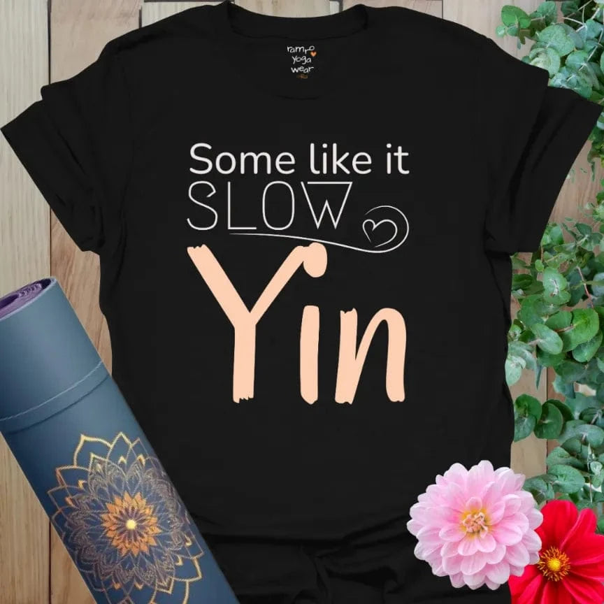 Black Yin T-Shirt with bold contrast peach and white design. Slow yoga shirt with grounding simplicity.