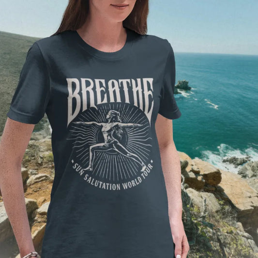 Ramro Yoga Wear Breathe tee in Indigo Blue — sun salutation world tour vintage design, coastal cliffs ocean lifestyle shot