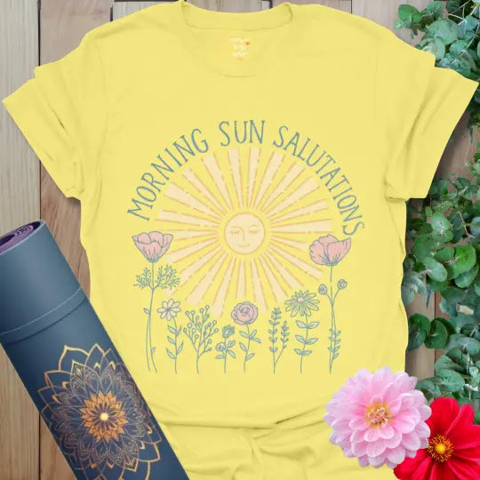 Cornsilk Morning Sun Salutations T-Shirt with gentle sunrise illustration and hand-drawn flowers. Warm and uplifting yoga tee.