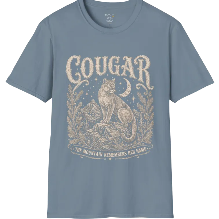 Cougar T-Shirt flat lay with a cougar perched on a mountain rock ledge beneath a crescent moon and pine framing — vintage engraved graphic tee by Ramro Yoga Wear in Stone Blue.