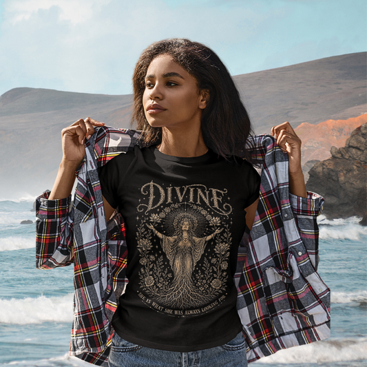 Woman wearing Divine black sacred yoga shirt at the ocean with coastal cliffs — Sacred Thread collection by Ramro Yoga Wear