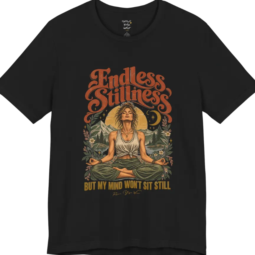 A short sleeved tee, showing an Illustration of a woman seated in lotus meditation pose in front of mountains, pine trees, and a crescent moon, framed by botanical leaves and flowers. Endless T-Shirt flat lay is a Bella+Canvas 3001 and the color is Black.