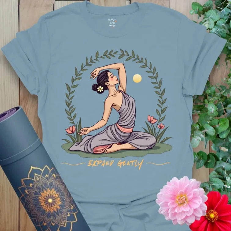 Muted stone blue yoga t-shirt featuring gentle expansion illustration with yogini, sun, and flowers for spiritual journeying.