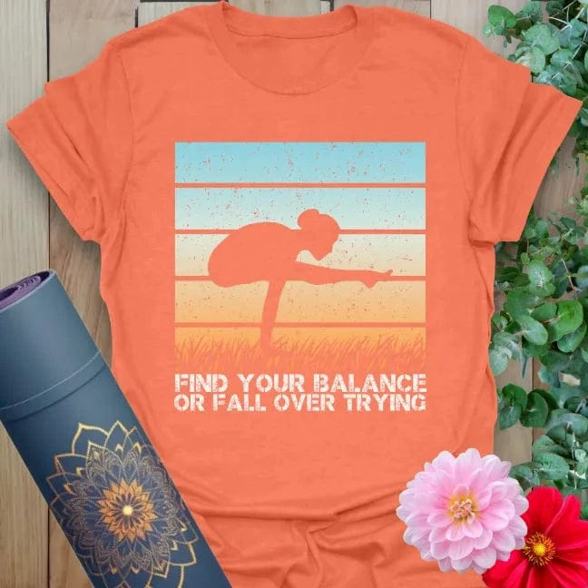 Vibrant orange yoga shirt with “find your balance” quote and yoga-inspired art