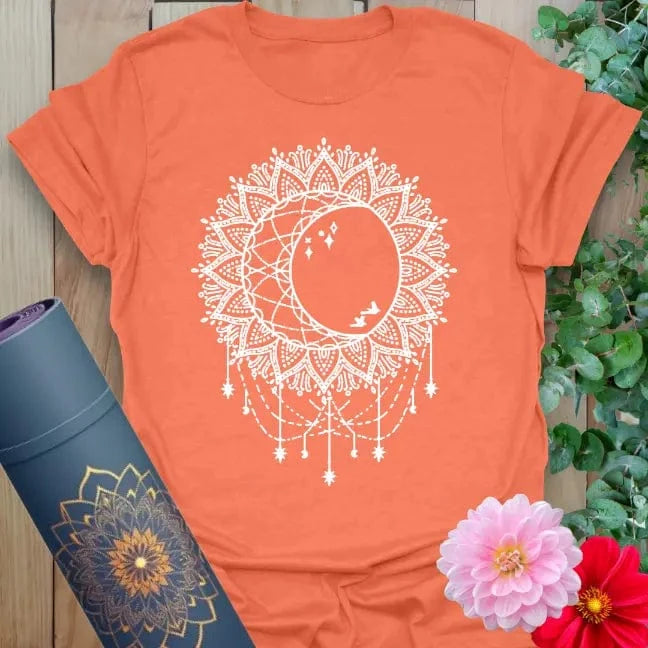 Heather orange celestial tee with sun, moon, and sacred geometry elements