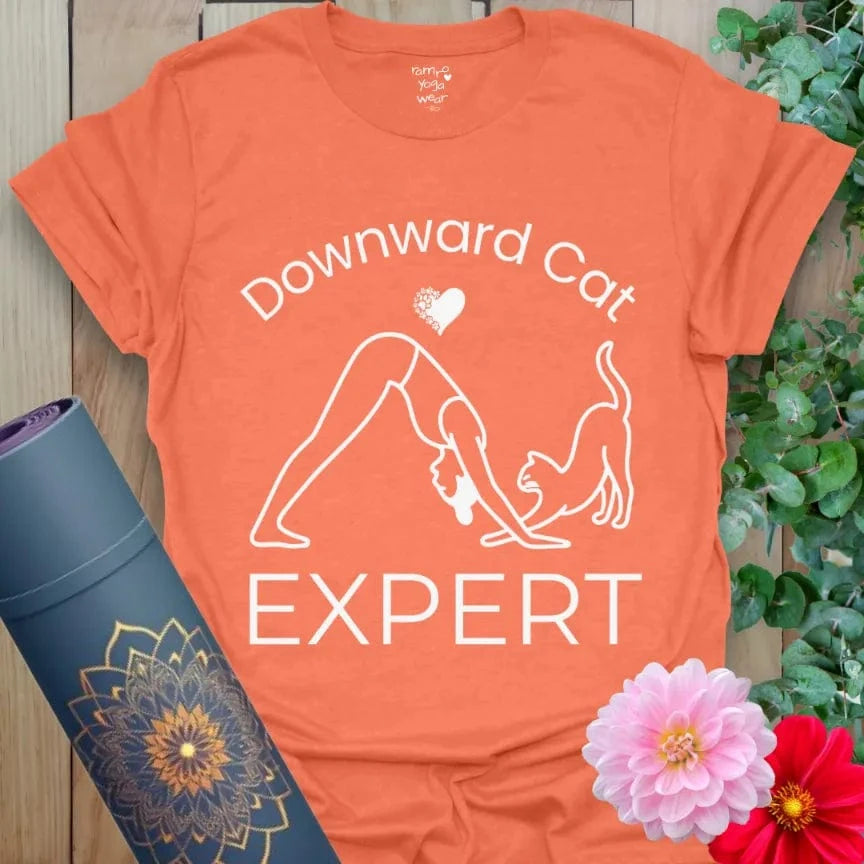 Heather Orange Cat Expert T-Shirt, yoga gift tee with playful cat and yogi illustration in Downward Dog, bold text "Downward Cat Expert."