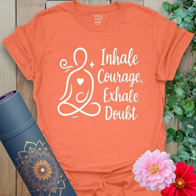 Heather orange t-shirt with bold "Inhale Courage, Exhale Doubt" affirmation and peaceful yoga art