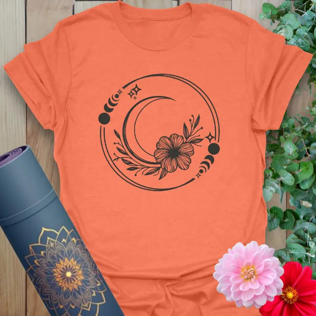 Heather orange t-shirt with crescent moon, floral accents, and divine feminine flow