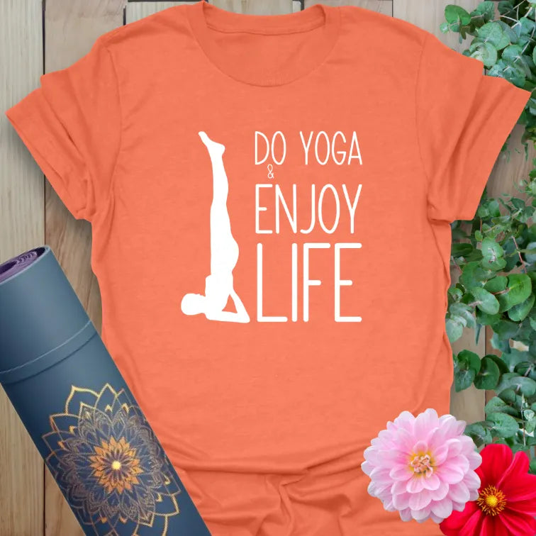 Vibrant orange yoga t-shirt featuring inspirational yoga quote and headstand pose for mindful living.