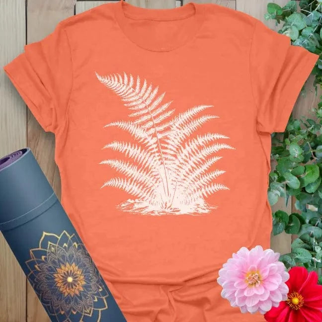 Vibrant orange yoga t-shirt showcasing graceful fern cluster artwork for outdoor mindfulness and soulful living.