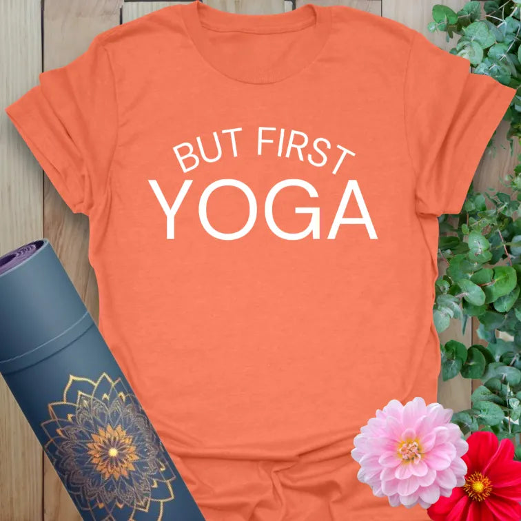 Vibrant orange yoga t-shirt showcasing playful "But First, Yoga" text for soulful, active living.