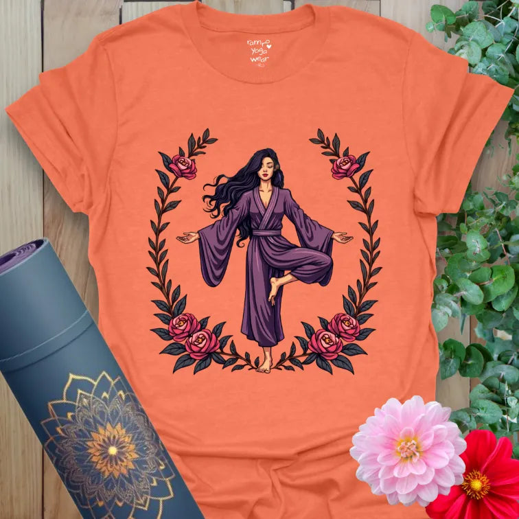 Vibrant orange yoga t-shirt showcasing empowered yogi and floral wreath artwork for soulful, heart-led movement.