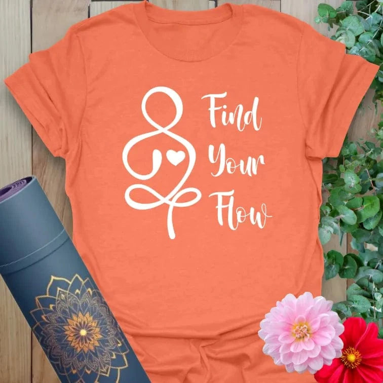 Vibrant orange yoga t-shirt showcasing flowing heart-centered illustration and motivational "Find Your Flow" mantra.