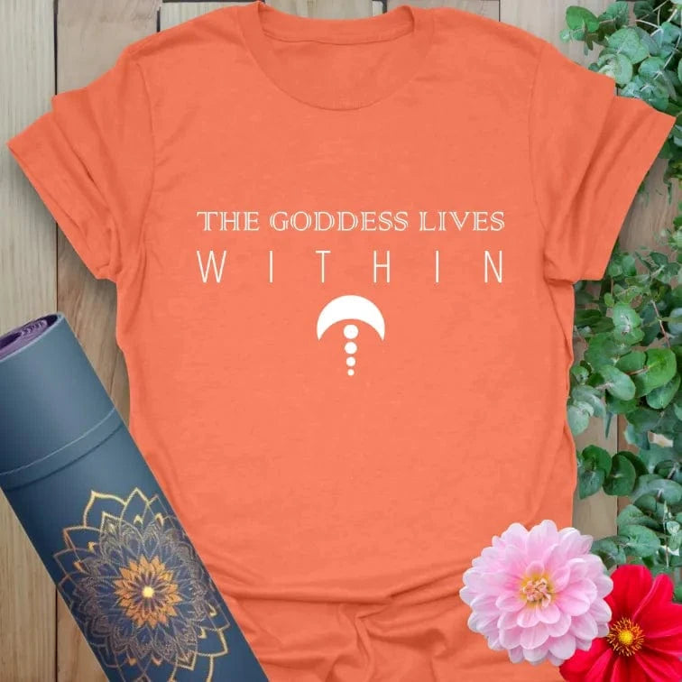 Vibrant orange yoga t-shirt showcasing empowering goddess affirmation and sacred symbol for soulful spiritual seekers.