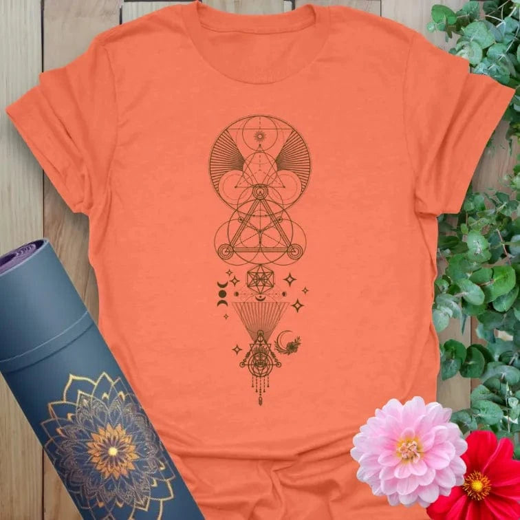 Vibrant orange yoga t-shirt showcasing intricate sacred geometry artwork inspiring spiritual growth and conscious movement.