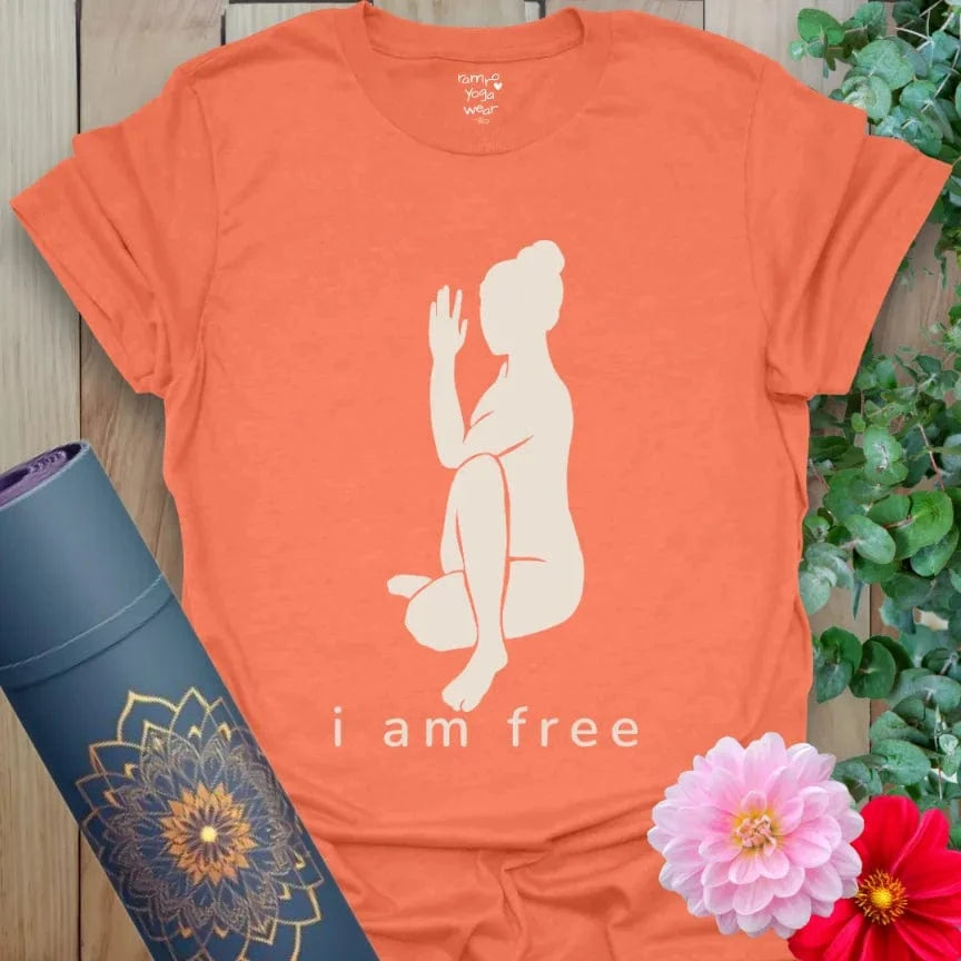 Heather Orange I Am Free T-Shirt featuring minimalist yogi line art in a twist pose with mantra “I Am Free.” Bold yoga gift shirt for liberation and flow.