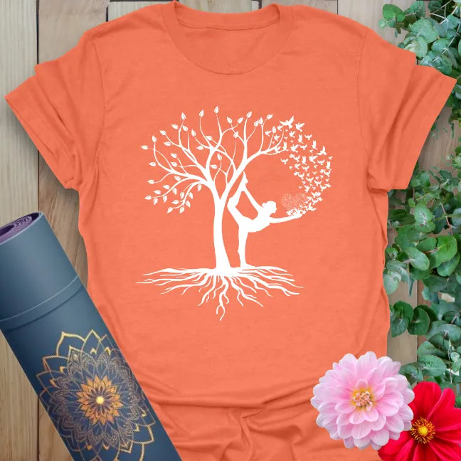 Vibrant orange yoga t-shirt showcasing graceful Tree Pose yogi and flourishing tree design for mindful, soulful living.