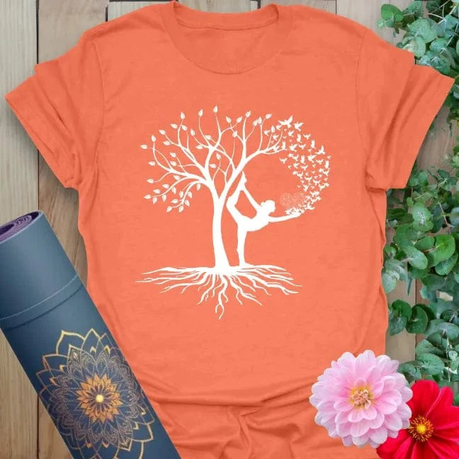 Vibrant orange yoga t-shirt showcasing graceful Tree Pose yogi and flourishing tree design for mindful, soulful living.