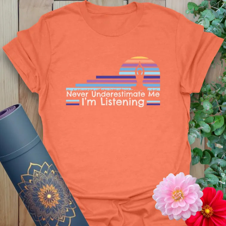 Vibrant orange yoga t-shirt showcasing colorful mindful listening design and strong soulful affirmation.
