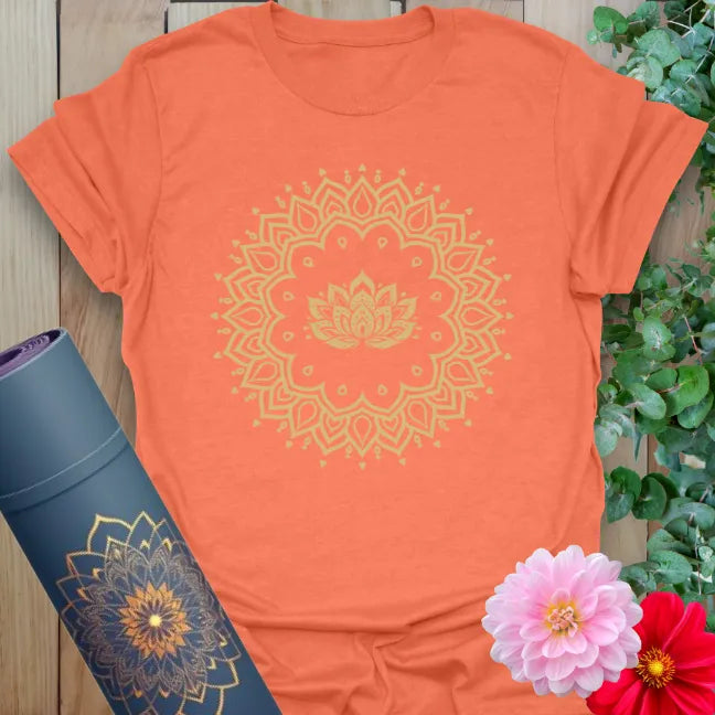 Vibrant orange yoga t-shirt showcasing sacred lotus mandala artwork perfect for conscious movement and soulful living.