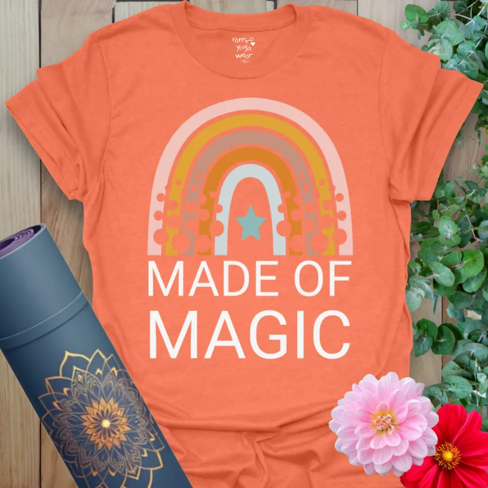 Vibrant orange yoga t-shirt showcasing bold "Made of Magic" rainbow artwork for soulful expression and joyful movement.