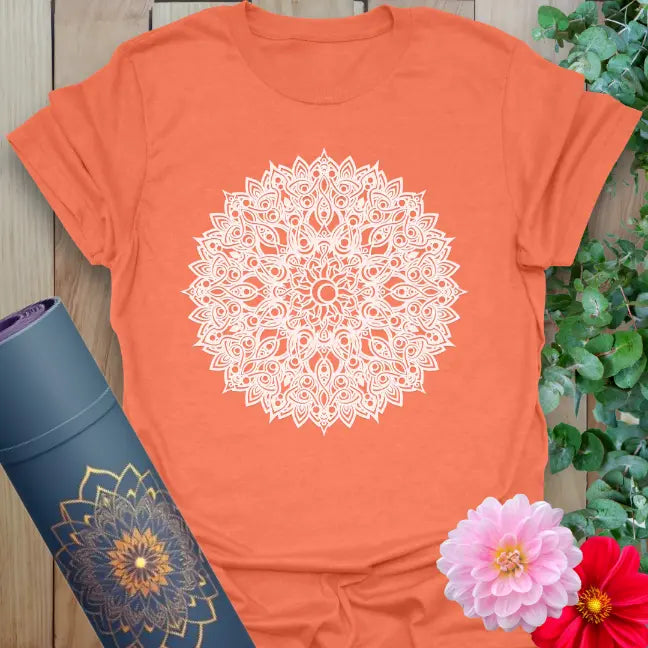 Vibrant orange yoga t-shirt showcasing detailed mandala artwork inspiring presence, peace, and conscious movement.