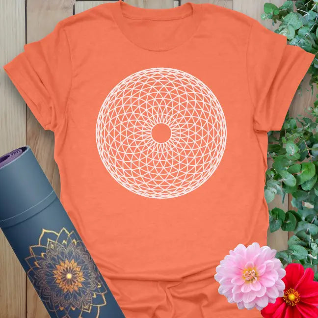 Vibrant orange yoga t-shirt showcasing sacred circular pattern inspiring mindful manifestation and soulful alignment.