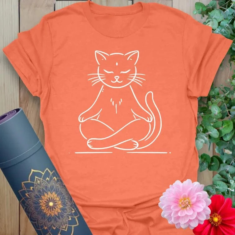 Vibrant orange yoga t-shirt showcasing serene cat in meditation pose inspiring light-hearted mindfulness and joyful presence.