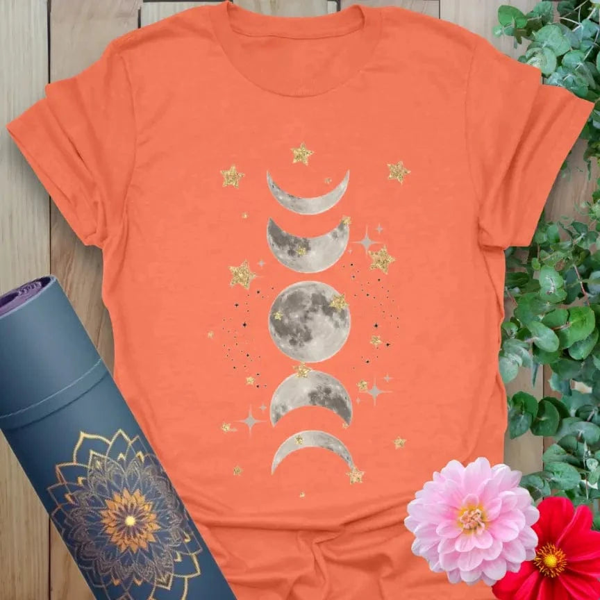 Vibrant orange yoga t-shirt showcasing mystical moon phases and starry artwork inspiring intuitive, mindful living.