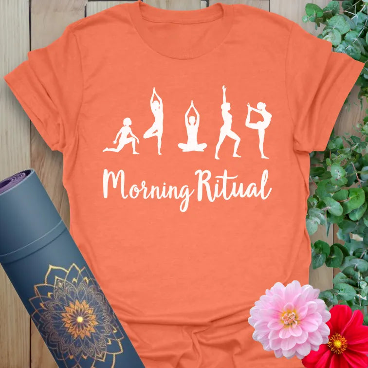 Vibrant orange yoga t-shirt showcasing morning yoga pose silhouettes and inspirational message for heart-centered, energized mornings.