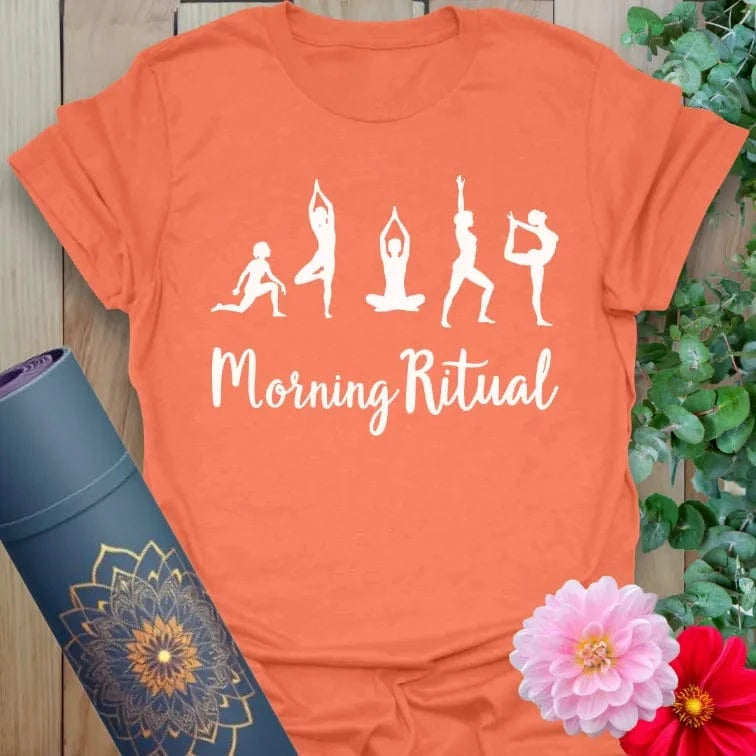 Vibrant orange yoga t-shirt showcasing morning yoga pose silhouettes and inspirational message for heart-centered, energized mornings.