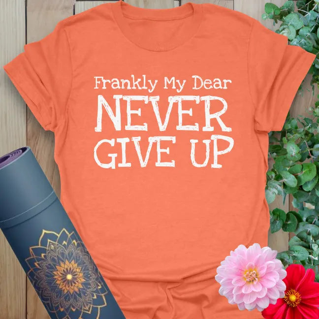Vibrant orange yoga t-shirt showcasing bold motivational message inspiring conscious determination and courageous living.