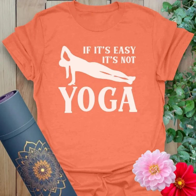 Vibrant orange yoga t-shirt showcasing playful yoga humor design inspiring joyful challenge and conscious growth.