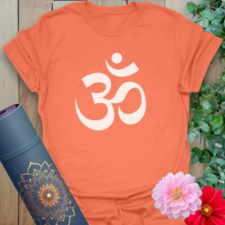 Vibrant orange yoga t-shirt showcasing sacred Om design inspiring conscious living, meditation practice, and soulful alignment.