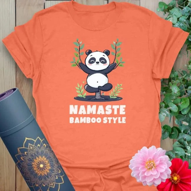 Vibrant orange yoga t-shirt showcasing cute panda design celebrating playful mindfulness and positive movement.