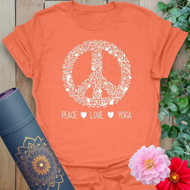 Vibrant orange yoga t-shirt showcasing blooming peace symbol and conscious living quote inspiring mindful movement.