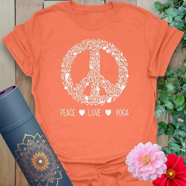 Vibrant orange yoga t-shirt showcasing blooming peace symbol and conscious living quote inspiring mindful movement.