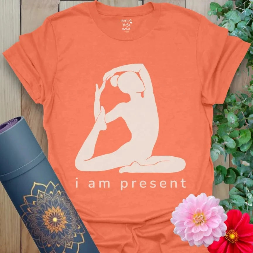 Heather Orange Present T-Shirt featuring yoga silhouette in King Pigeon Pose. Positive affirmation “i am present” tee.